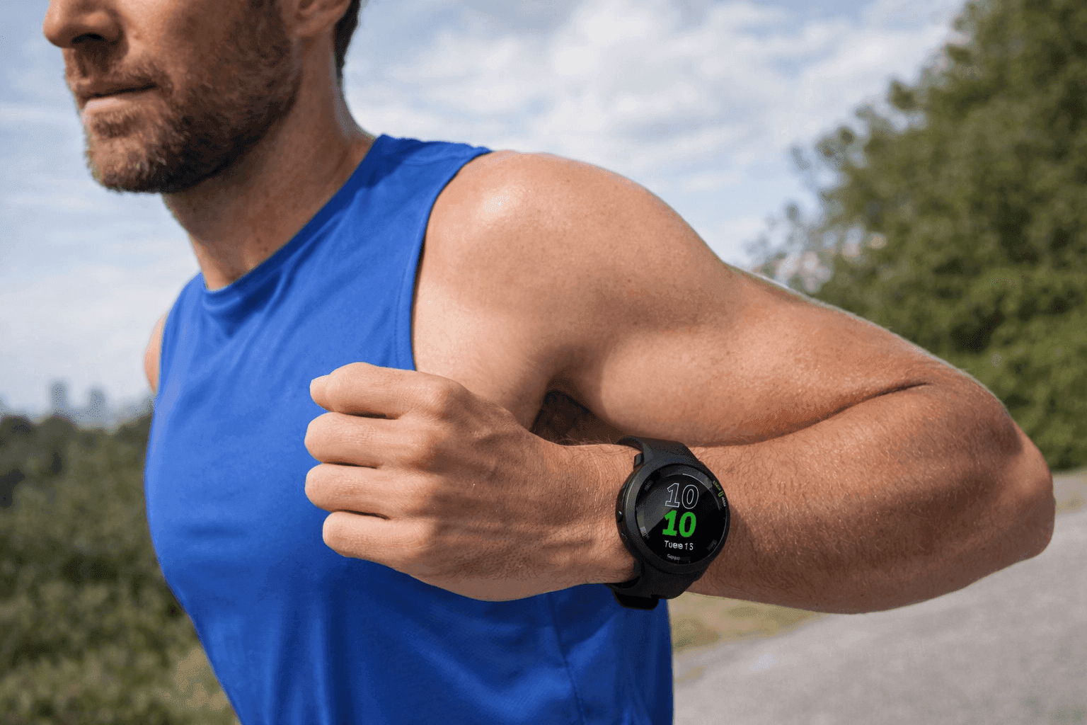 Man wearing a Garmin Forerunner 55 GPS running watch while jogging outdoors, showing real-time stats on a lightweight fitness tracker for runners